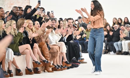 The crowd applaud Chemena Kamali walking the runway during the Chloé womenswear show.