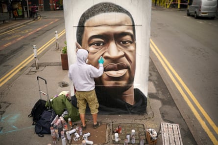 Graffiti artist Akse spray paints a mural of George Floyd in Manchester’s northern quarter in June 2020.