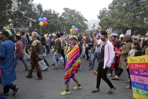 A participant wears a piece of cloth with colors of the rainbow as gay rights activists and their supporters march during a gay pride parade in New Delhi
