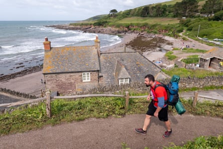A man walking along the coastline