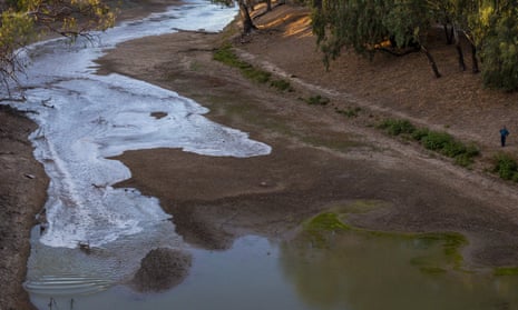 A new flow is seen meeting pools of green water along the Darling Barka river in Louth, Australia