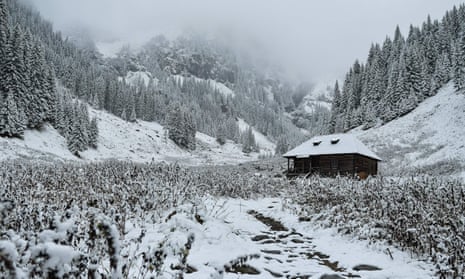 Snow covered fir trees surround a cabin at Valea Rea (The Bad Valley) on Fagaras mountains near Nucsoara, in central Romania.