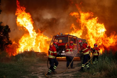 Firefighters, fire engine and wall of flame
