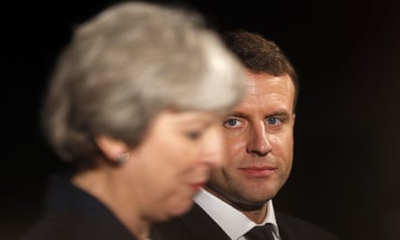 Emmanuel Macron listens to Theresa May speaking at the Victoria and Albert museum in London on Wednesday.