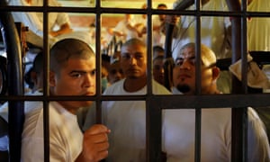 Inmates, members of the MS-13 gang, wait in their cell to be transferred from the Chalatenango penitentiary, in Chalatenango, El Salvador, on 27 December 2019.
