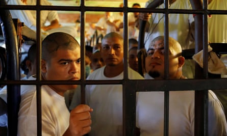 Inmates, members of the MS-13 gang, wait in their cell to be transferred from the Chalatenango penitentiary, in Chalatenango, El Salvador, on 27 December 2019.