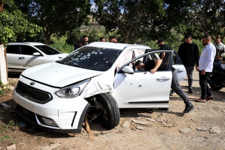 Palestinians inspect a car where one of two people were killed during an Israeli raid, in the West Bank city of Tubas, on Friday.