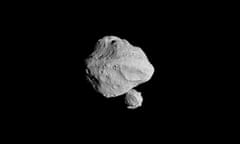 A pitted gray rock lit against the black backdrop of space.