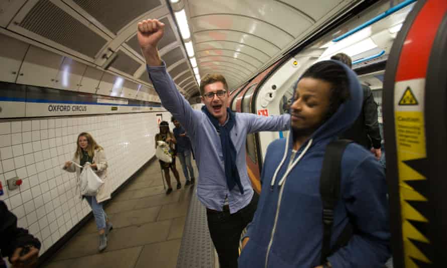 A man shouts while boarding a central line train at Oxford Circus station on the night of the launch of the 24-hour tube service.