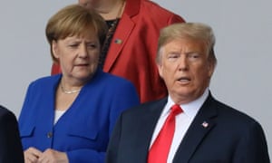 Merkel and Trump are seen as they pose for a family photo at the start of the summit.