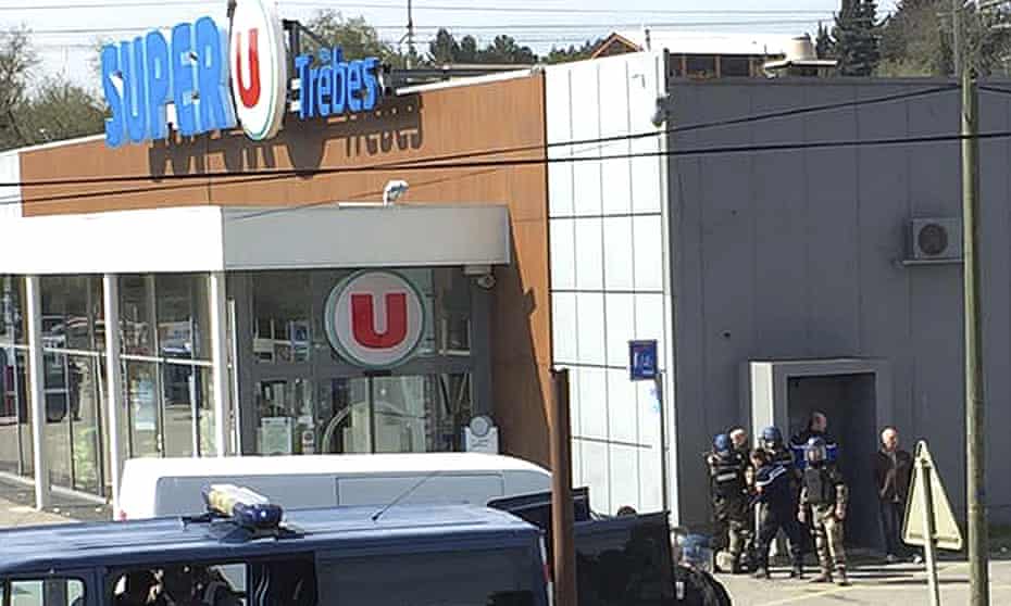 Police outside the supermarket in Trèbes, southern France. An armed man initially took eight people hostage.
