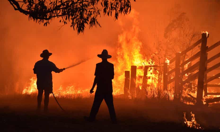 Residents defend their property from a bushfire in Hillsville, New South Wales, in November 2020