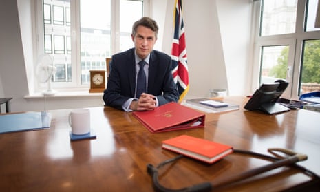 Gavin Williamson at desk with flag in background and whip in foreground