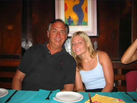 A middle-aged man and a younger woman smile.
