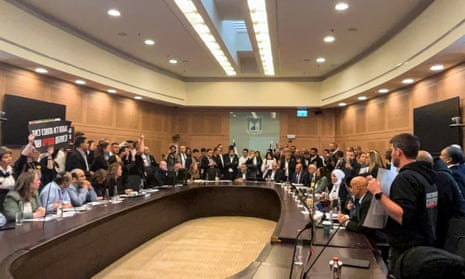 Relatives of Israelis who have been held hostage by Hamas militants since 7 October, storm a parliamentary committee session demanding that the lawmakers do more to try to free their loved ones, in Jerusalem on 22 January 2024.