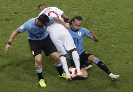 Uruguay’s Cristian Rodriguez, left, and Diego Laxalt, right, challenge for the ball with Portugal’s Ricardo Quaresma.