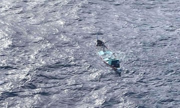 Aerial shot of a small, partially submerged boat.