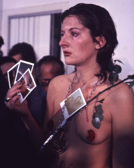 Marina Abramović in Rhythm 0, in which she placed 72 objects on a table and allowed the audience to use them on her however they wished.
