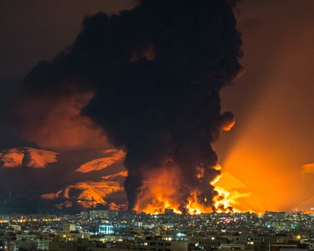 Smoke and flames about Tehran after airstrikes on an oil depot last month