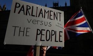 A protester holds a placard outside the Houses of Parliament before the vote on Thursday.