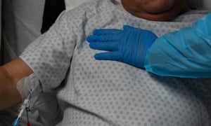 A health worker comforts a patient in hospital