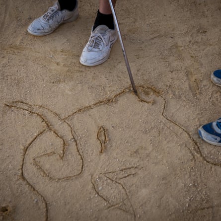 A student draws a bull in the sand in Venta de Antequera.