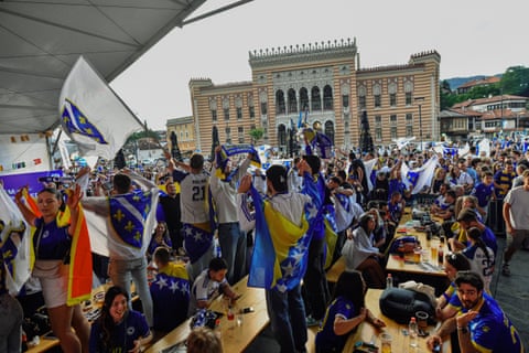 Both flags on display as crowds gathered in a square in Sarajevo for the Bosnia v Switzerland game.