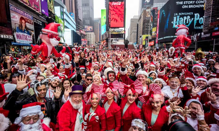 Hundreds of revelers bedecked in Santa costumes gather in New York City's Times Square for the start of the annual SantaCon bar crawl in 2019.