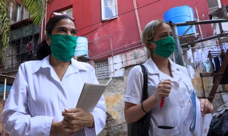 Dr Liz Caballero, left, and student Susana Díaz leave El Vedado polyclinic in Havana, to go door by door looking for possible coronavirus cases.
