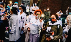 Medical workers at Lenox Hill hospital hold a candlelit vigil to remember the victims of the coronavirus.