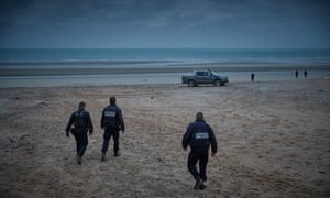 Police patrol the beach of Wimereux searching for migrants.