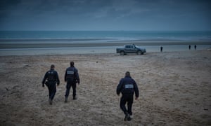 Police patrol the beach of Vimarex in search of migrants.