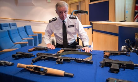 Bernard Hogan-Howe pictured with weapons seized by police officers in London.