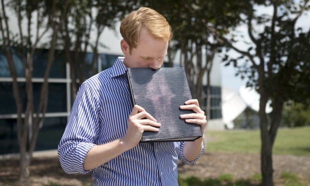 WDBJ news anchor Chris Hurst pauses as he is overcome with emotion while holding a photo album that was created by fellow reporter and girlfriend Alison Parker, in Roanoke, Virginia, in August 2015.
