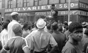 On 23 July 1967, Conyers uses a bullhorn to encourage African Americans in Detroit’s riot area to go home.