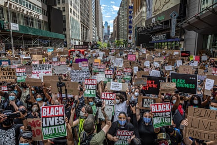 huge number of people march with signs that say ‘black lives matter’ and other slogans