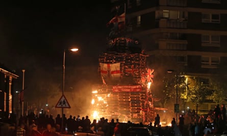 Crowds watch as a bonfire is lit in the New Lodge area of Belfast on Thursday night.