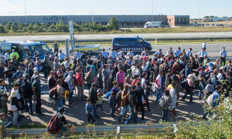 Refugees walking along a Danish motorway