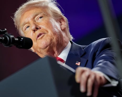 Donald Trump speaking at a lectern
