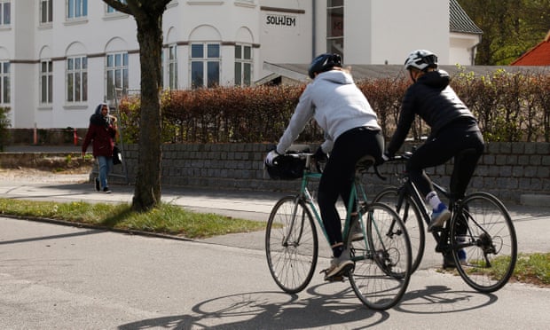 People ride bicycles in Aarhus, Denmark, where a strict lockdown has been relaxed.