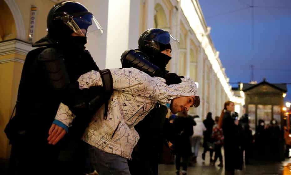 A demonstrator is taken away by law enforcement officers during a rally in support of jailed opposition figure Alexei Navalny in St Petersburg