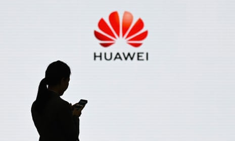 Woman in front of Huawei sign.