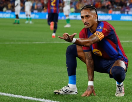 Raphinha crouches and poses like Spider-Man after scoring his side’s second goal from the penalty spot during La Liga match between Barcelona and Racing de Santander