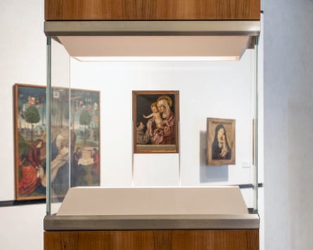 A painting depicting a Madonna and baby exhibited in a display case.