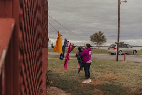 A seasonal laborer from Oaxaca, Mexico, hangs clothes to dry outside the home she rents from her employer on Hoopers Island, Maryland.