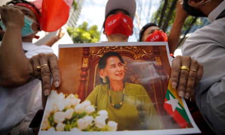 Myanmar democracy protesters in Bangkok hold a picture of jailed ex-leader Aung San Suu Kyi