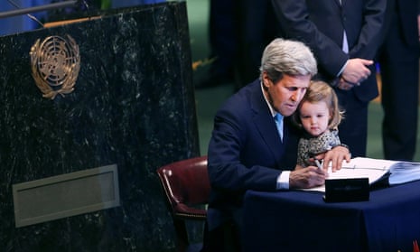 US secretary of state John Kerry holds his granddaughter as he signs the Paris climate agreement.