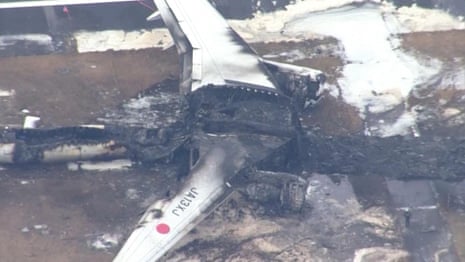 Aerial images of plane wreckage after crash at Japan's Haneda airport – video