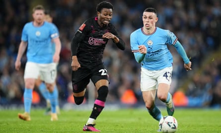 Phil Foden on the ball for Manchester City, under pressure from Burnley’s Nathan Tella