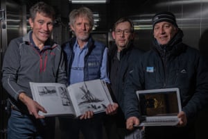 Left to right: team members Shears, Bound, Nico Vincent, expedition subsea manager, and JC Caillens, offshore manager, hold the first scan of Endurance wreckage alongside photos by Hurley